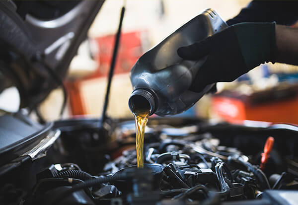Pouring Oil During Oil Change Service