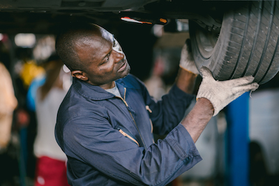 auto mechanic working on tire rotation service