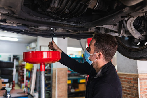 oil change being performed on car