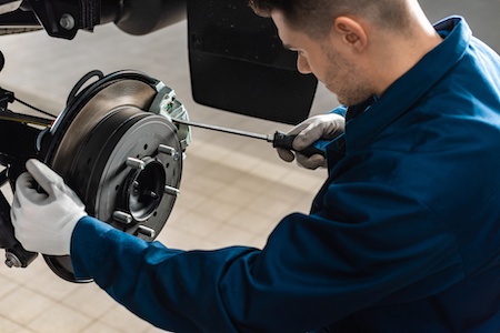 auto mechanic working on brake repairs