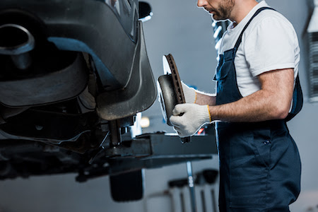 auto mechanic holding car brake during a repair