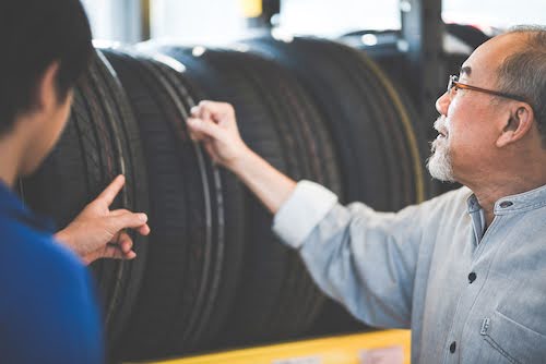 customer and mechanic shopping for tires